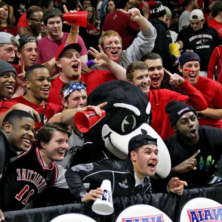 Rocky Raven with cheering students at a sporting event